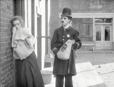 Charles Chaplin and Leota Bryan in Easy Street (1917)