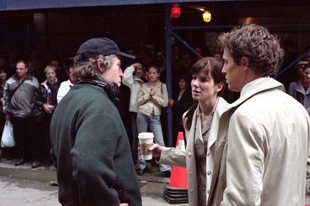 Director Marc Lawrence on the set with Sandra Bullock and Hugh Grant