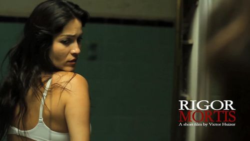 Zamia Fandiño and Victor Huizar in Rigor Mortis (2012)