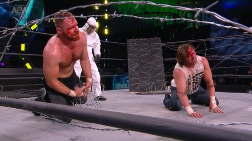 Kenny Omega, Jonathan Good, and Bryce Remsburg in All Elite Wrestling: Revolution (2021)