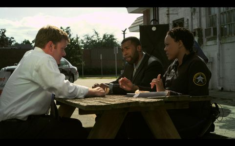 Mitch (Chip Lane) is grilled by Taylor (Chris Watson) and Theresa (Kwajalyn Brown)