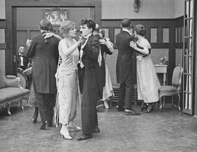 Charles Chaplin, Leota Bryan, and Edna Purviance in The Adventurer (1917)