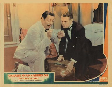 John Garrick and Warner Oland in Charlie Chan Carries On (1931)